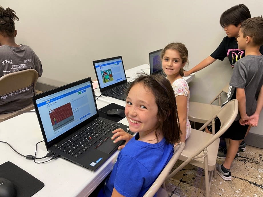 Two girls sitting at computers during The Woodlands Children's Museum Fall Program