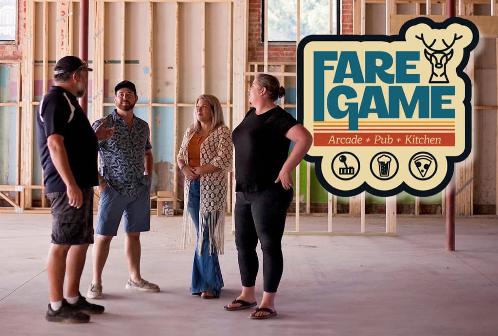 Owners of Fare Game stand in the building during construction