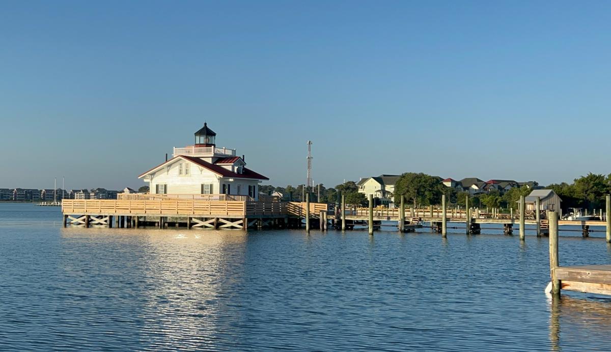 Calm sound waters surrounding Marshes Light and a view of the walkway and boardwalk at the Manteo waterfront.