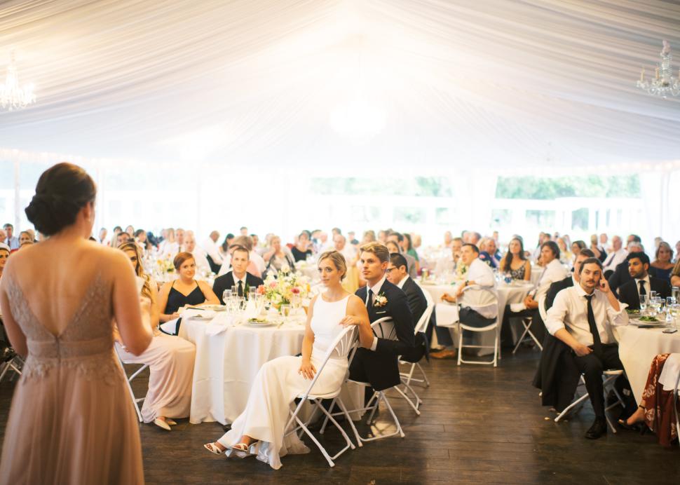 Maid of Honor giving toast inside tent