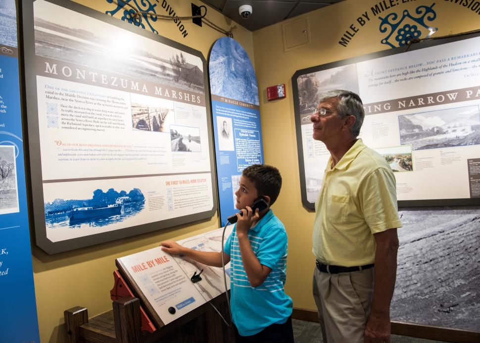Father and son at interior exhibit at Erie Canal Museum