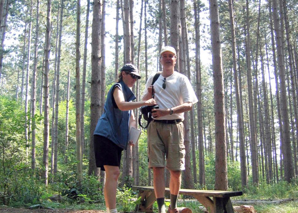 A couple prepares for a hike outside at the Cummings Nature Center