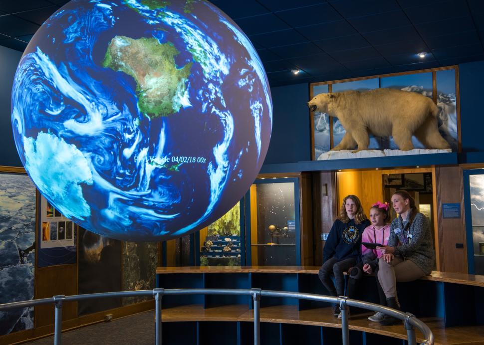 Family looking at earth exhibit at Rochester Museum & Science Center
