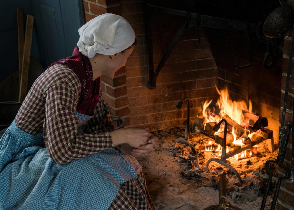 Woman cooking on fire at Genesee Country Village & Museum