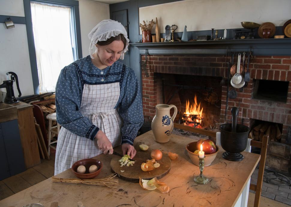 Woman in kitchen cooking at Genesee Country Village & Museum