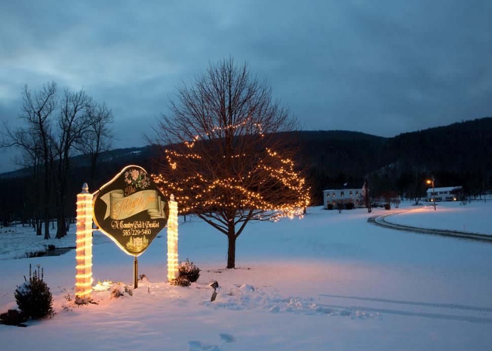 Exterior sign for Filigree Inn Bed and Breakfast lit up in the wintertime