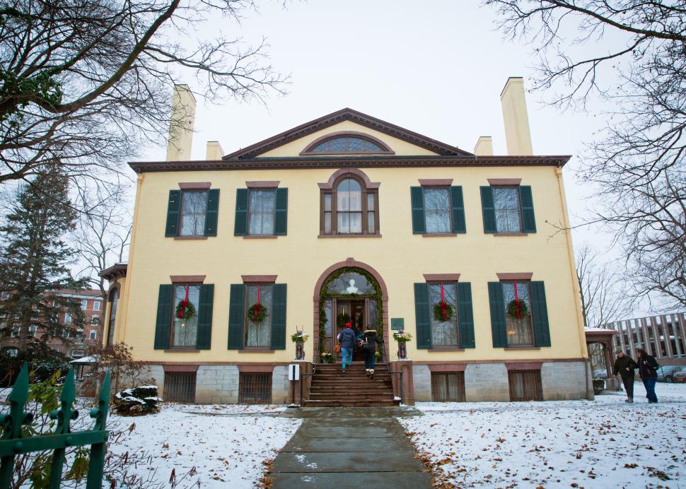Seward House Museum exterior, fence, and trees in the Winter
