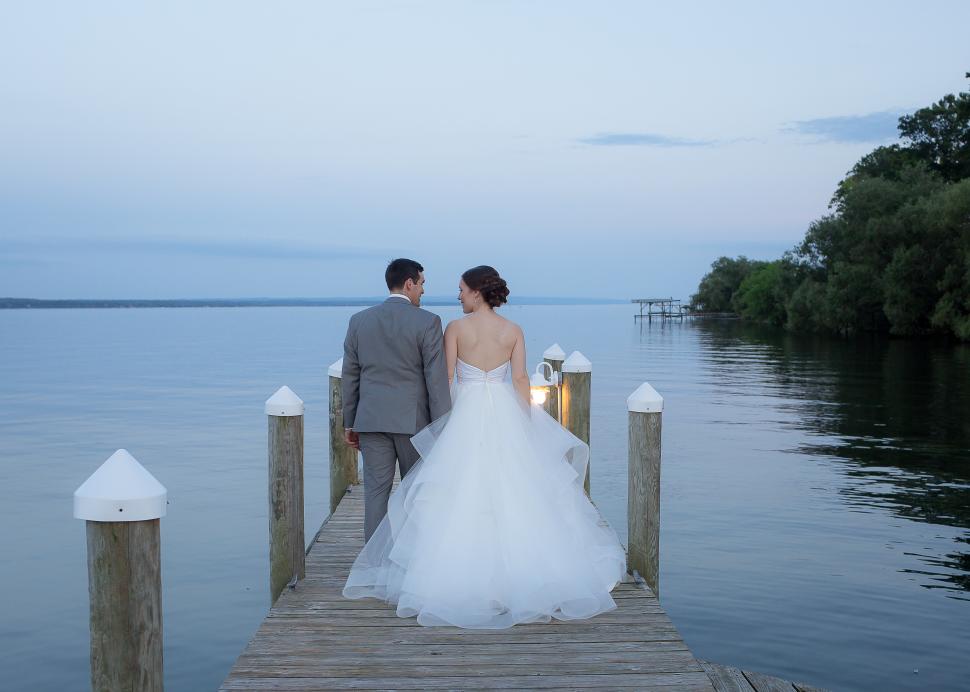 Couple on dock outside Belhurst after ceremony