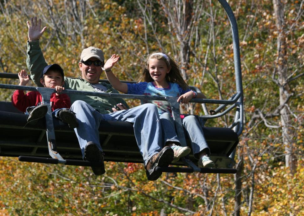 A Family at Bristol Mountain Waves for a photo on the chairlift