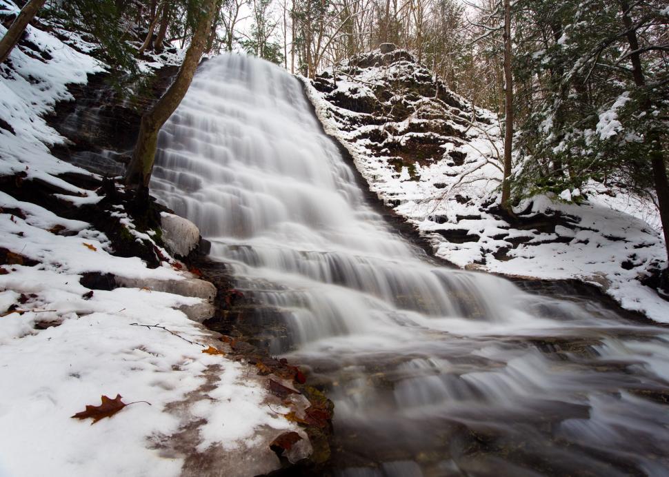 A waterfall rushes during the winter at Grimes Glen in Naples