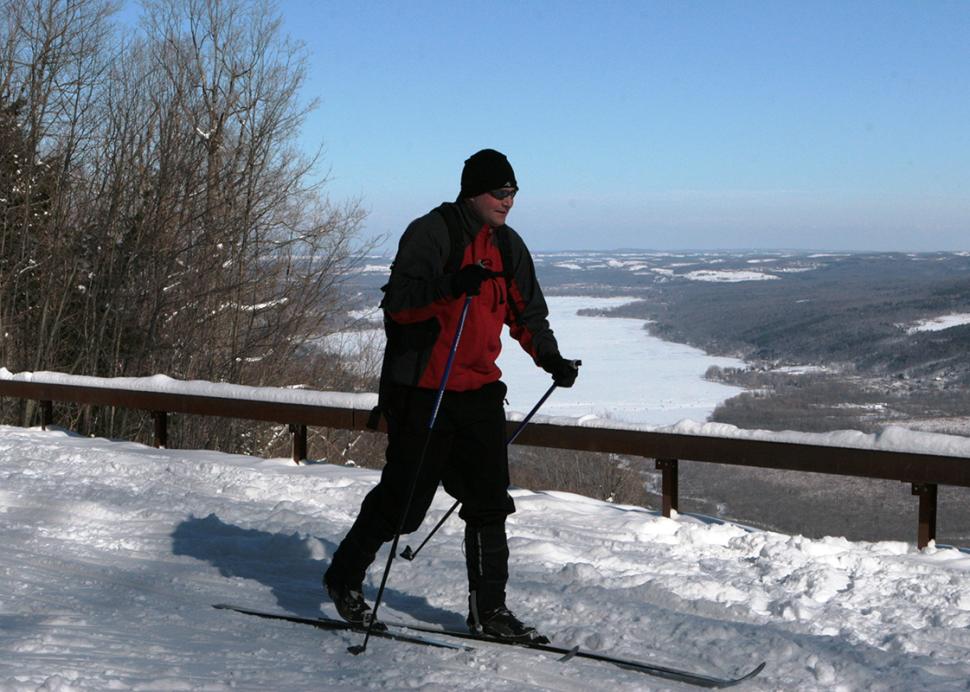 harriet-hollister-state-park-winter-solo-cross-country-skier-passing-overlook-blue-skies