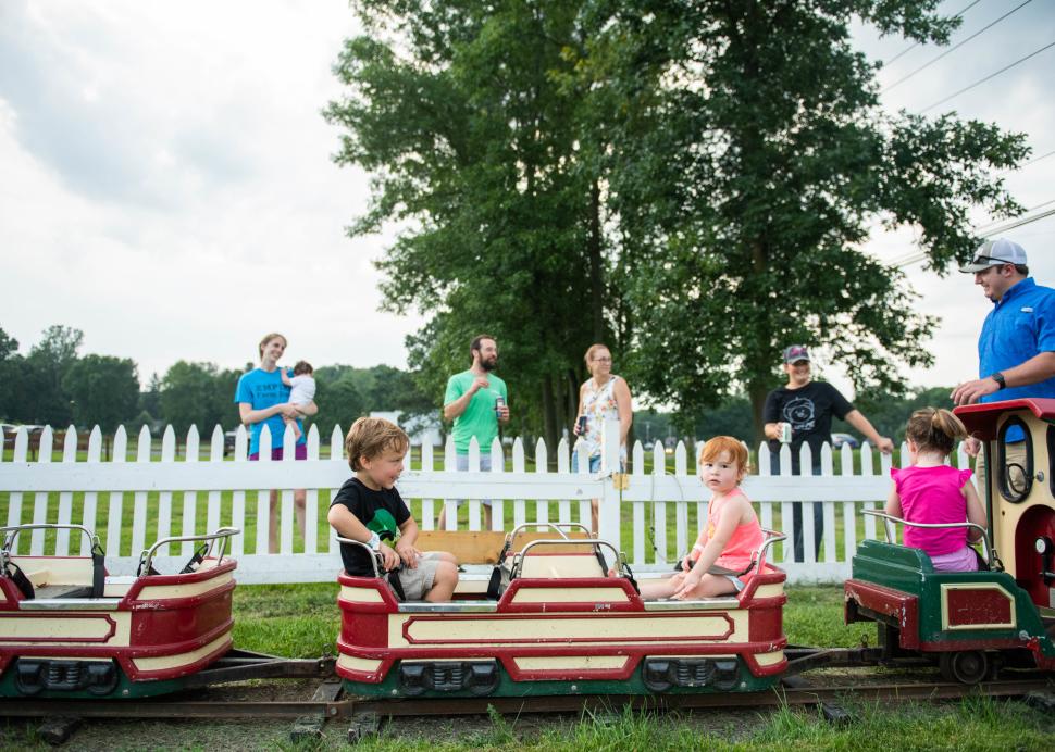 A kid enjoys a miniature train ride at the Pick n' Patch in Stanley