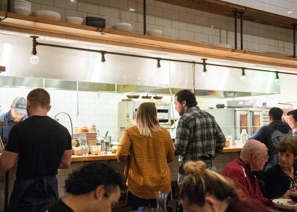 A crowd gathered around the bar at Kindred Fare