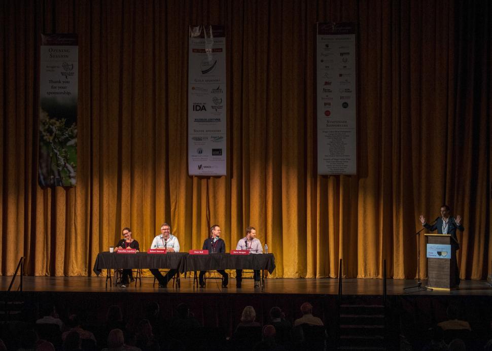 A table holds four speakers during an event at the Smith Center for the Arts