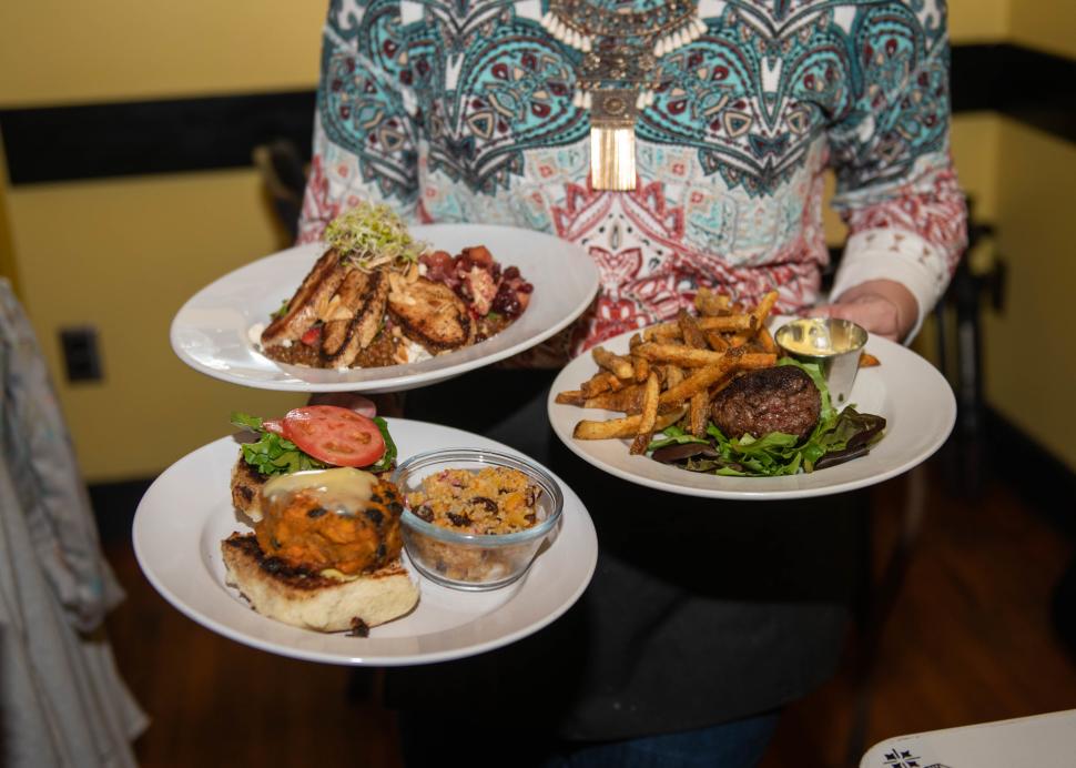 Three plates of food sit waiting to be eaten at Roots Cafe in Naples