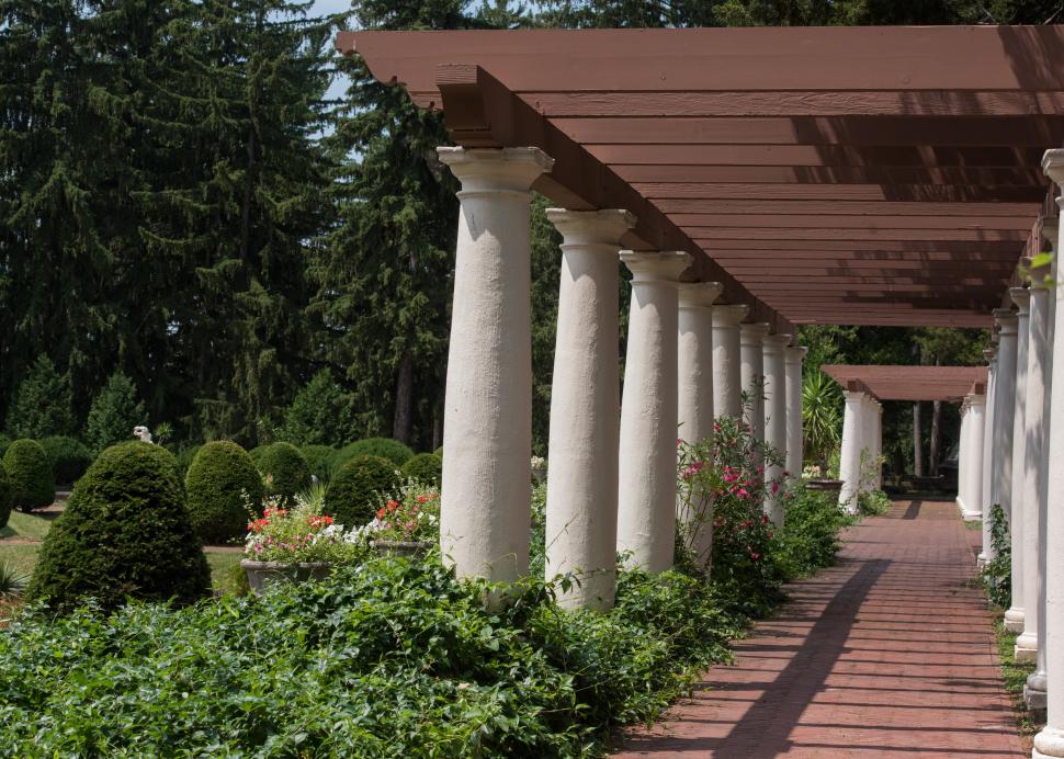 Large marble columns line a walkway at Sonnenberg Mansion in Canandaigua