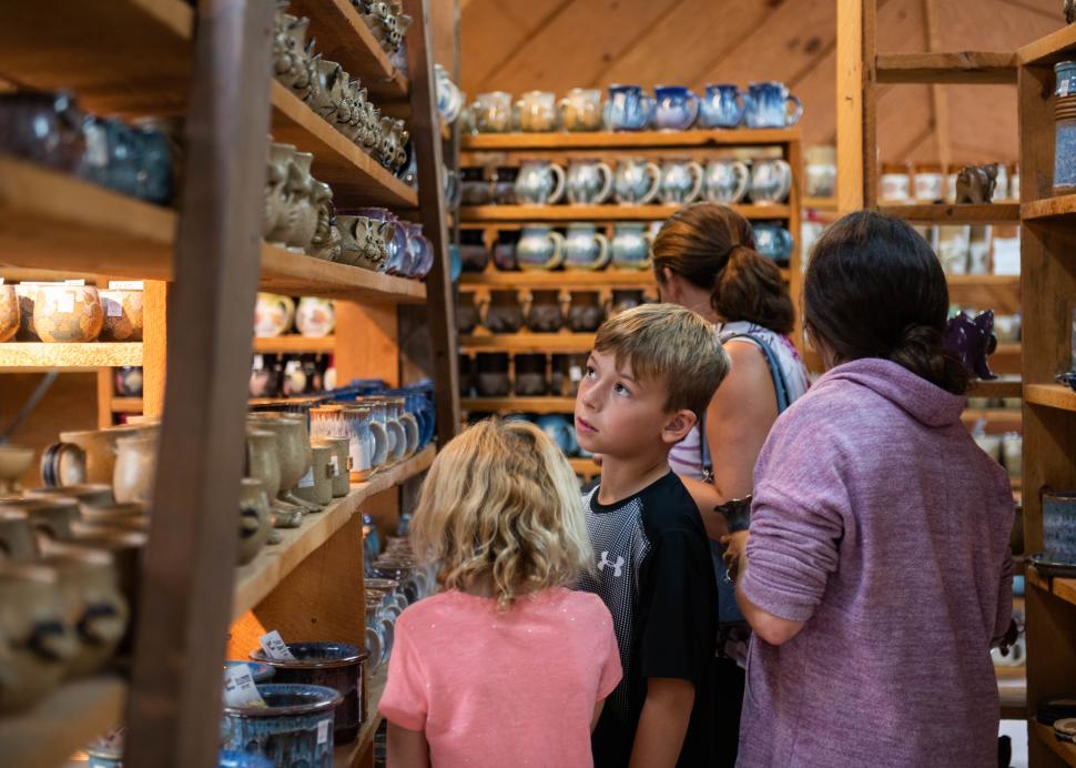 A family check out items inside of the Wizard of Clay pottery in Bloomfield
