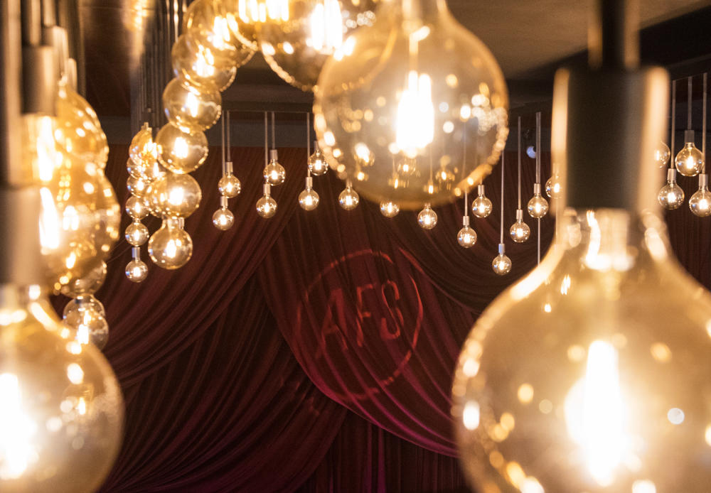 Lights and logo on red curtains at AFS Cinema