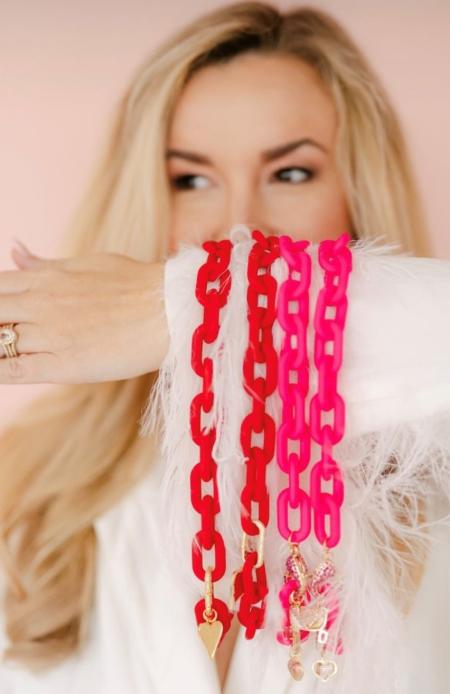 Model holding HIVE designs Acrylic Necklaces