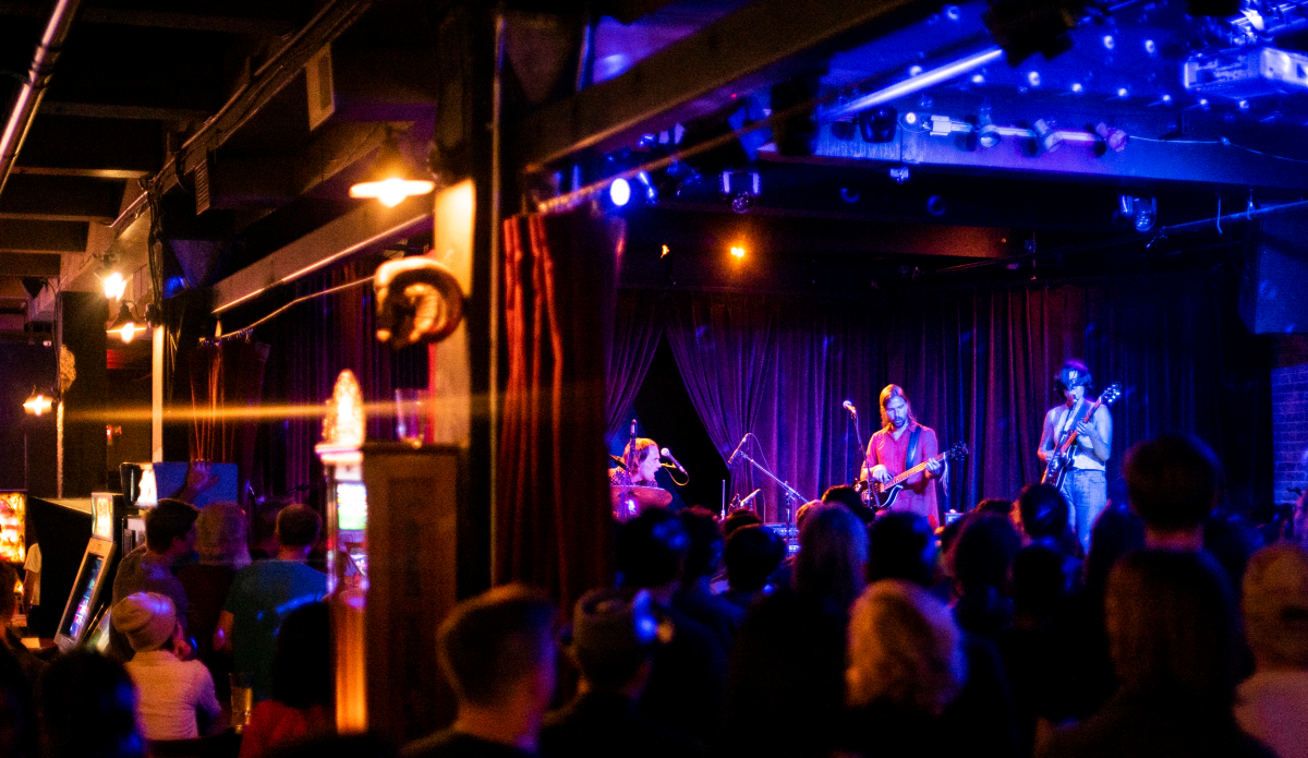 Musicians performing on stage at Sister Bar in Albuquerque.