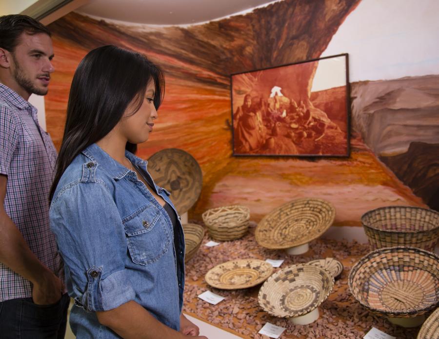 A woman and man view Mimbres baskets in the Mimbres Museum in Deming, New Mexico