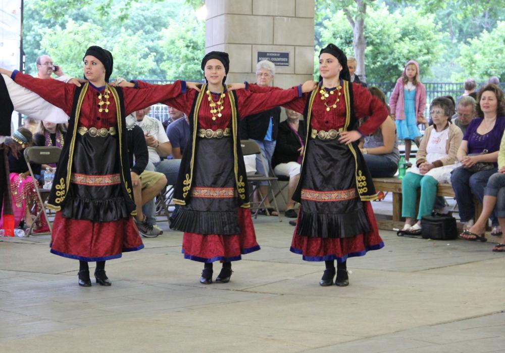 Three women dancing in greek costumes