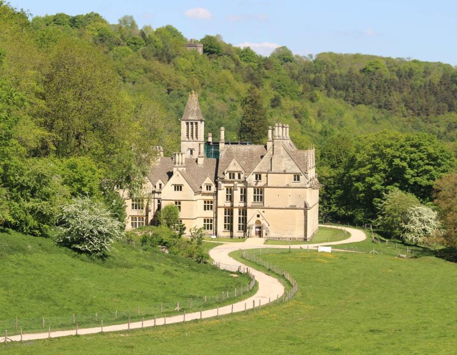 The impressive Victorian Gothic Woodchester Mansion surrounded by trees