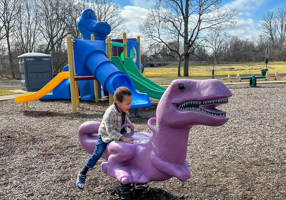 Child playing on playground at Draper meadows nature preserve