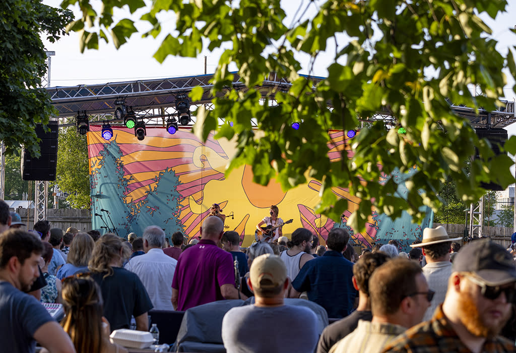 A woman performs on stage at Bell's Brewery in the summer time.
