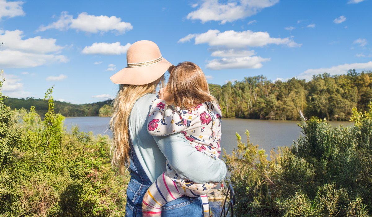 Mother holding child overlooking the Morgan Falls Reservoir at Morgan Falls Overlook Park