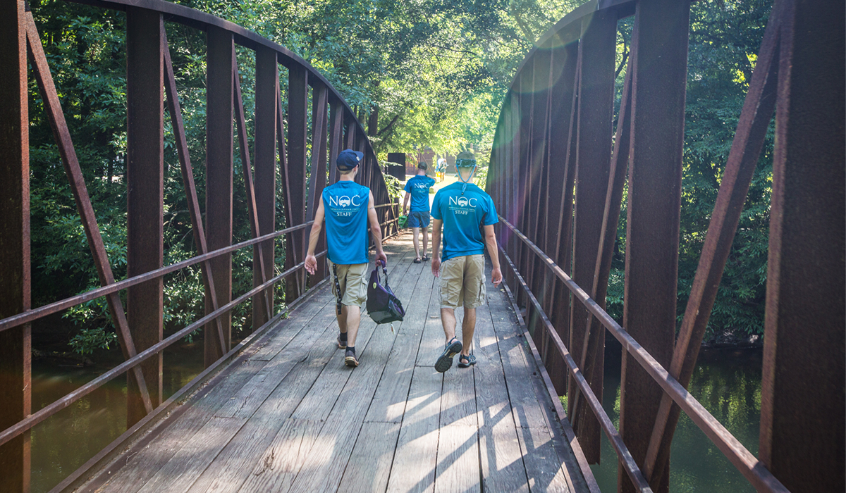 Group walking on bridge at Powers Island