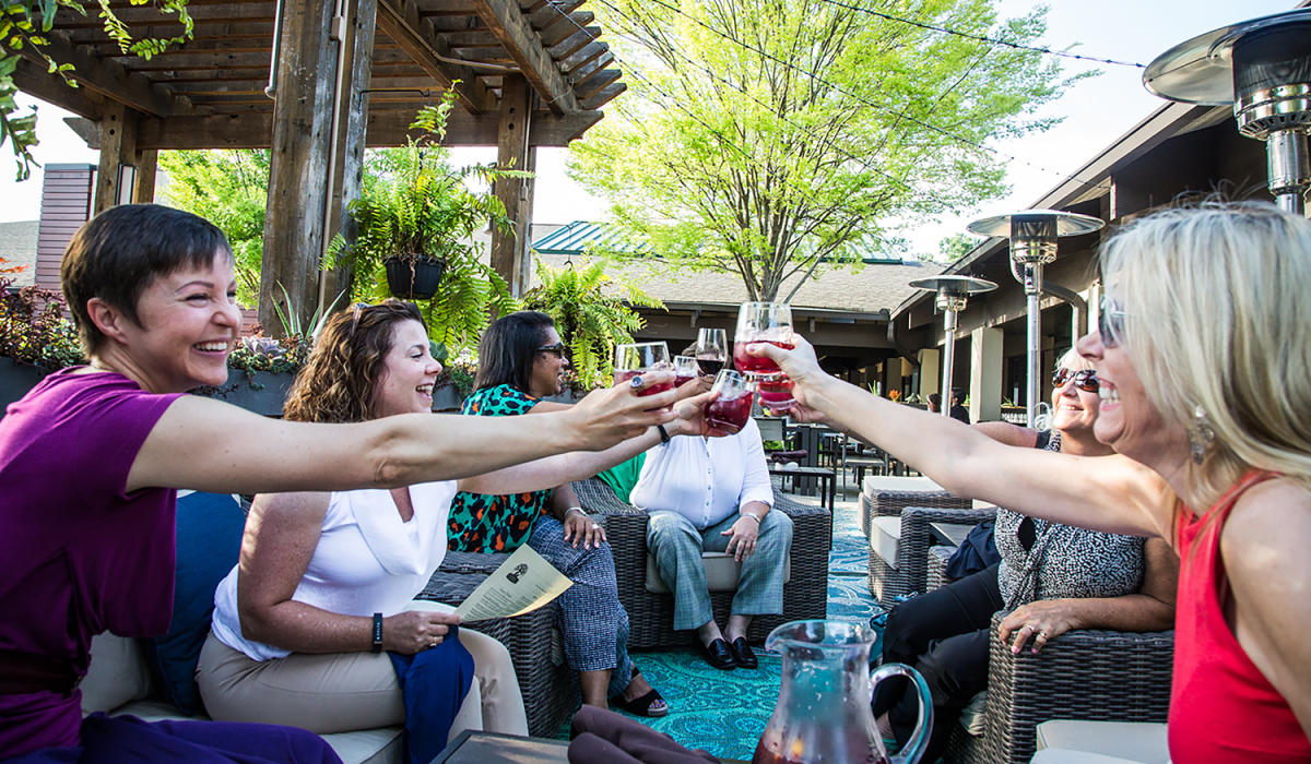 Women on Patio of Under the Cork Tree enjoying wine