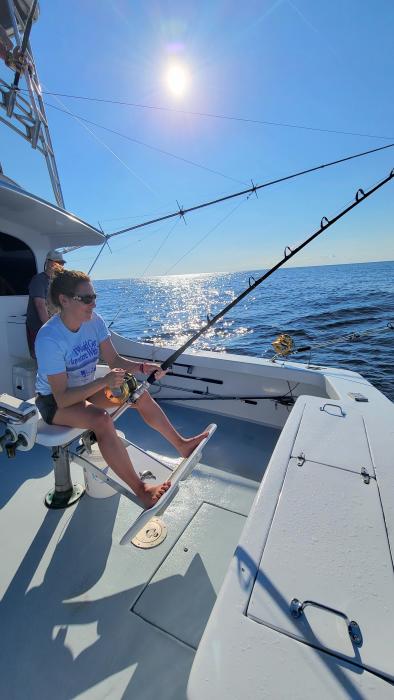 Woman Tuna Fishing Off The Back Of A Charter Boat In The Outer Banks Of NC
