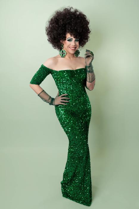 A glamour shot of drag performer Violet S'Arbleu, wearing a bright green sequined dress and dark curly hair, in attendance of the Dinner, Drag & Dancing event at The Westin.