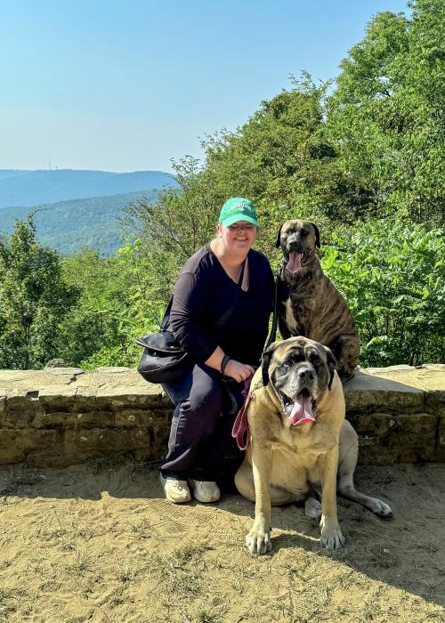 Woman poses with two dogs at a scenic overlook on Monte Sano Mountain in Huntsville.