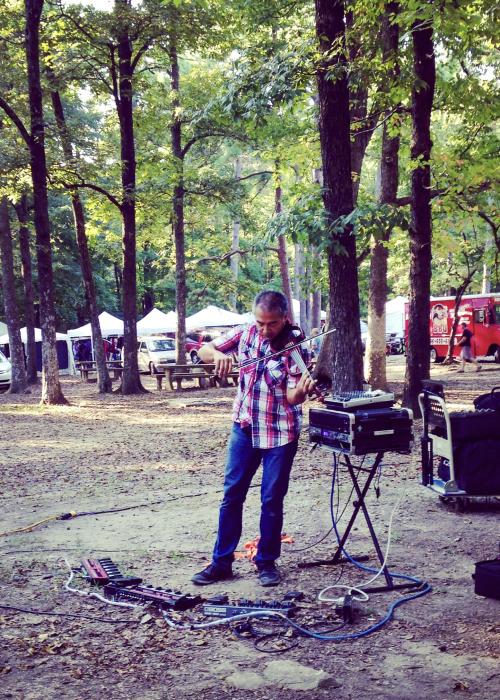 Musician plays the violin among the trees at the Monte Sano Art Festival in Huntsville.