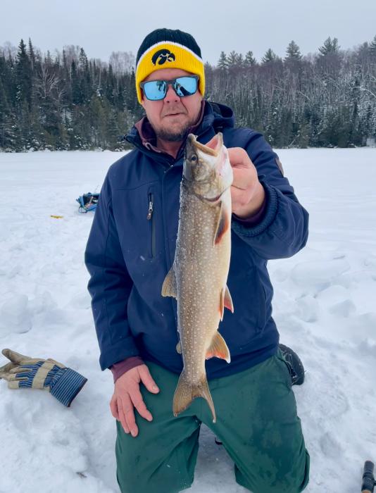What a catch! Ice fisherman showing off his best catch of the day.