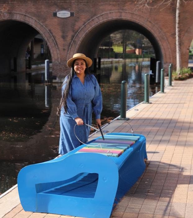 Instagram influencer playing with xylophone art bench