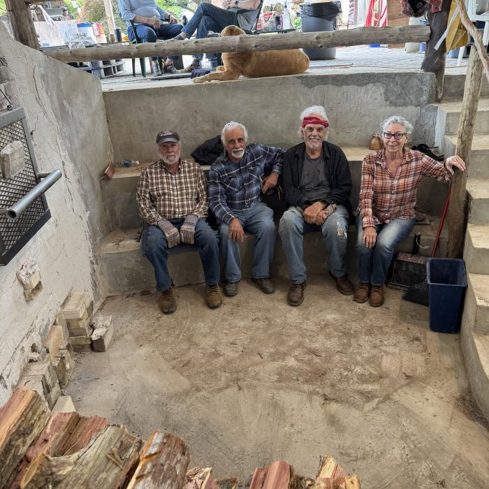 From left to right, Davis Abner, John Barnes, Richard Heodrr, and Kim Waller pause during the wood fired kiln firing at Finch Pottery in Bailey.