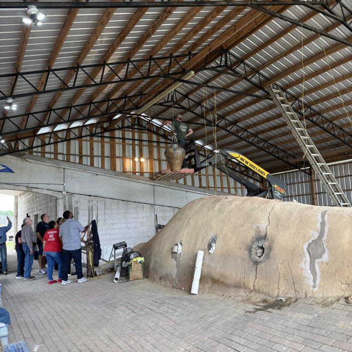 Dan Finch's large pottery vessel is positioned above the massive wood fired kiln where it serves as the counterweight for the kiln door at Finch Pottery in Bailey.