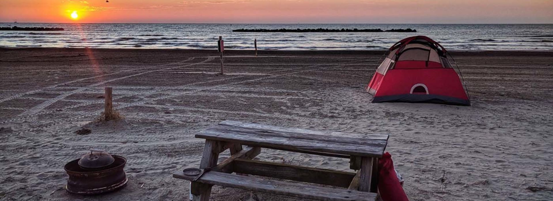 A Grand Isle beach campsite at sunset