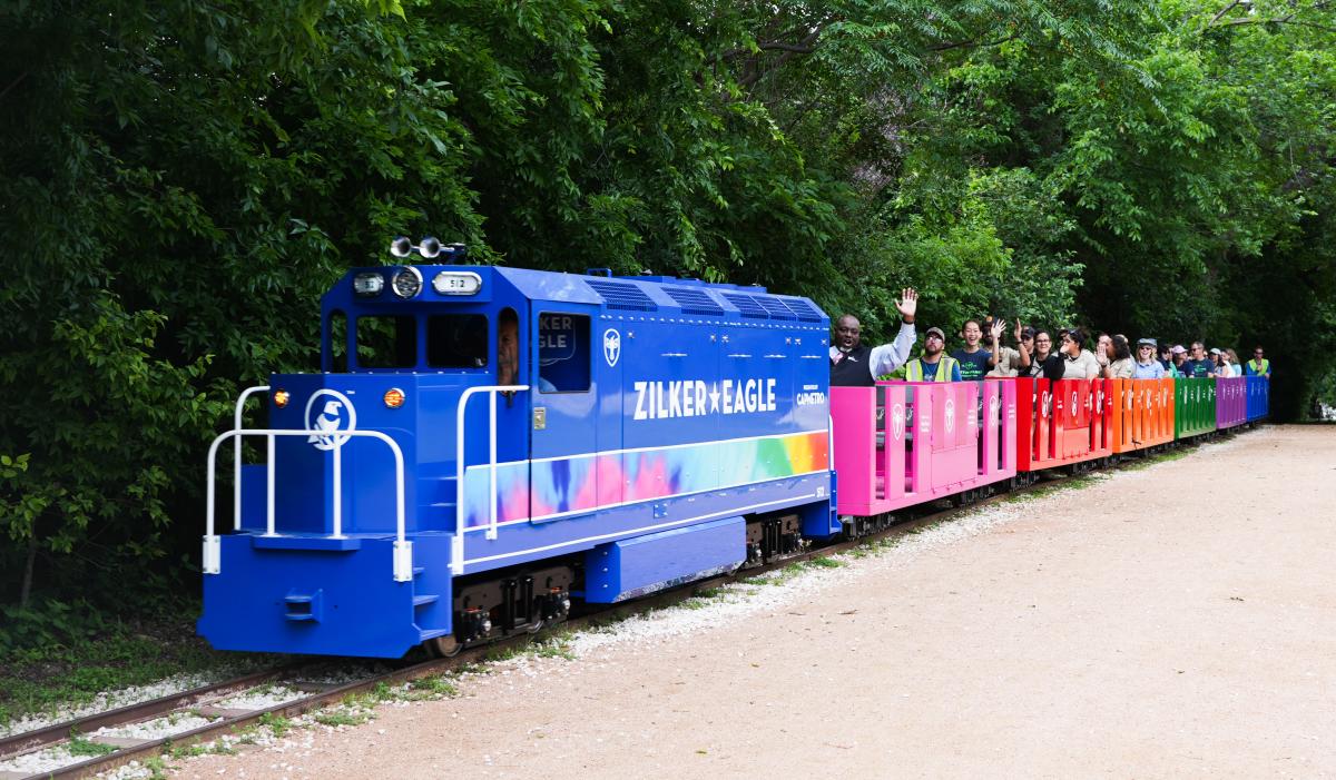 Image of people riding the colorful Zilker Eagle train.