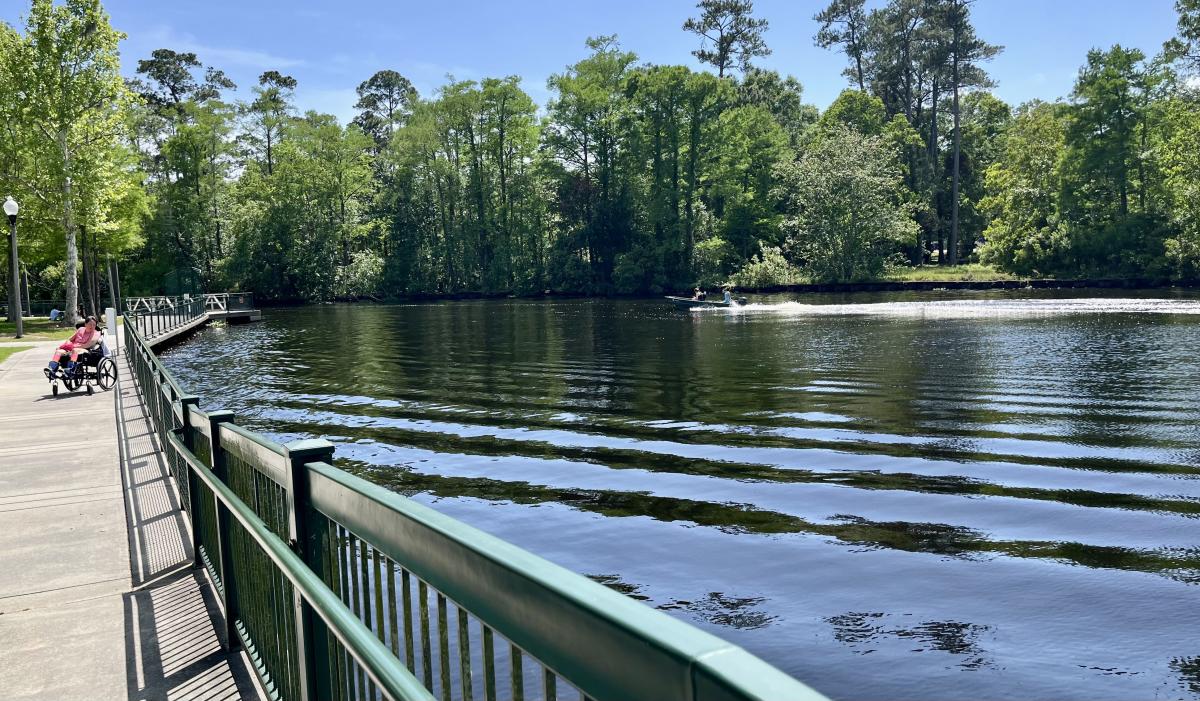 PJ Paulsell pauses along the accessible waterfront promenade overlooking Bayou Bonfouca at Heritage Park in Slidell.