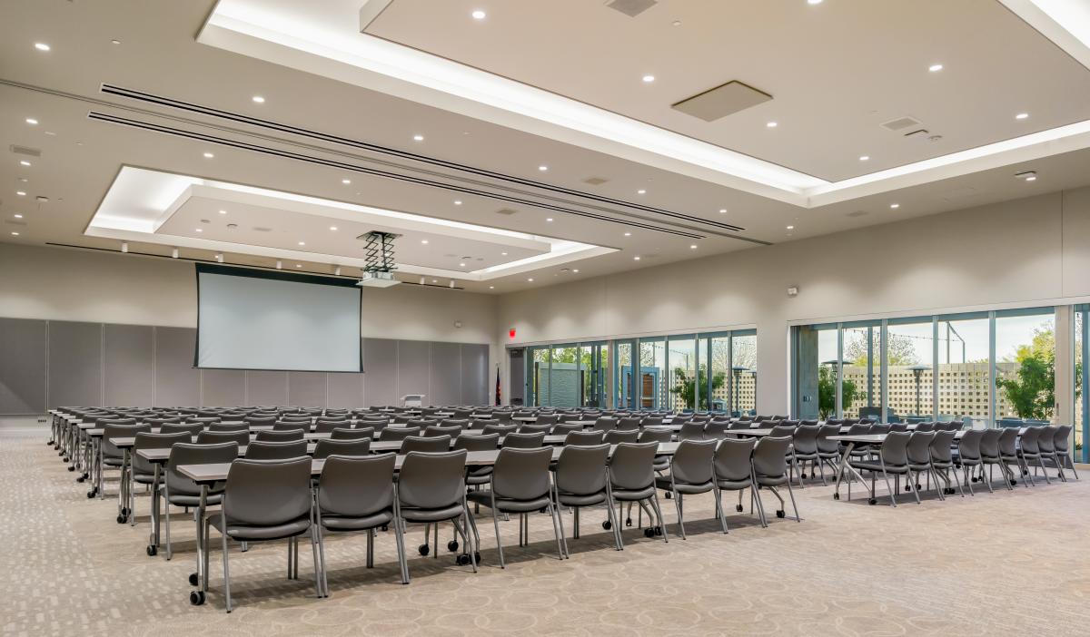 ballroom featuring windows at the Avion Center set with 60 chairs and a screen