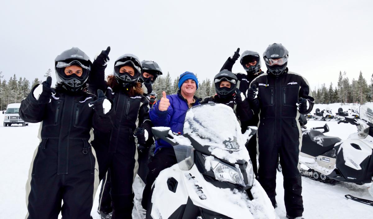 Snowmobile Tour Group with Snowmobiles in the Snow
