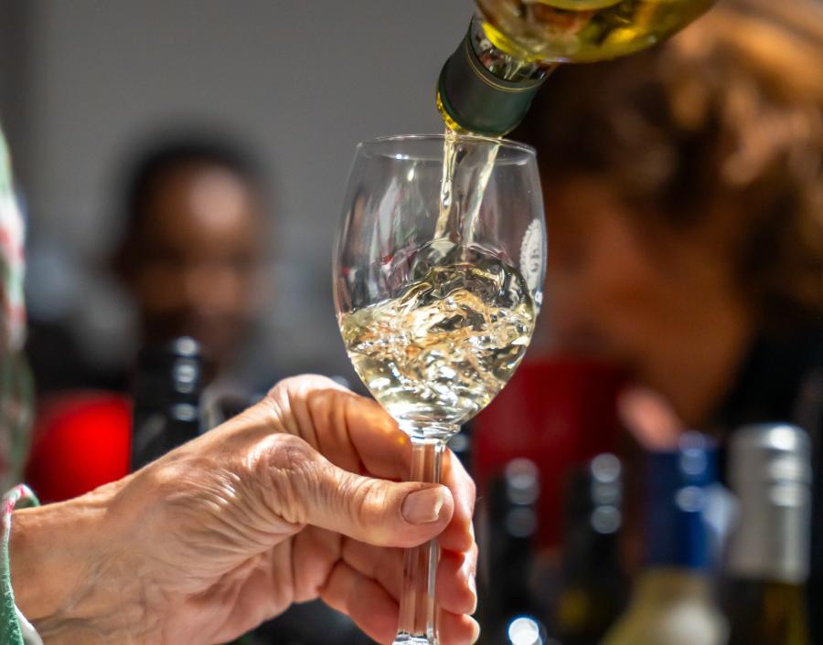 Wine being poured into a glass, highlighting the experience of tasting in the Finger Lakes.
