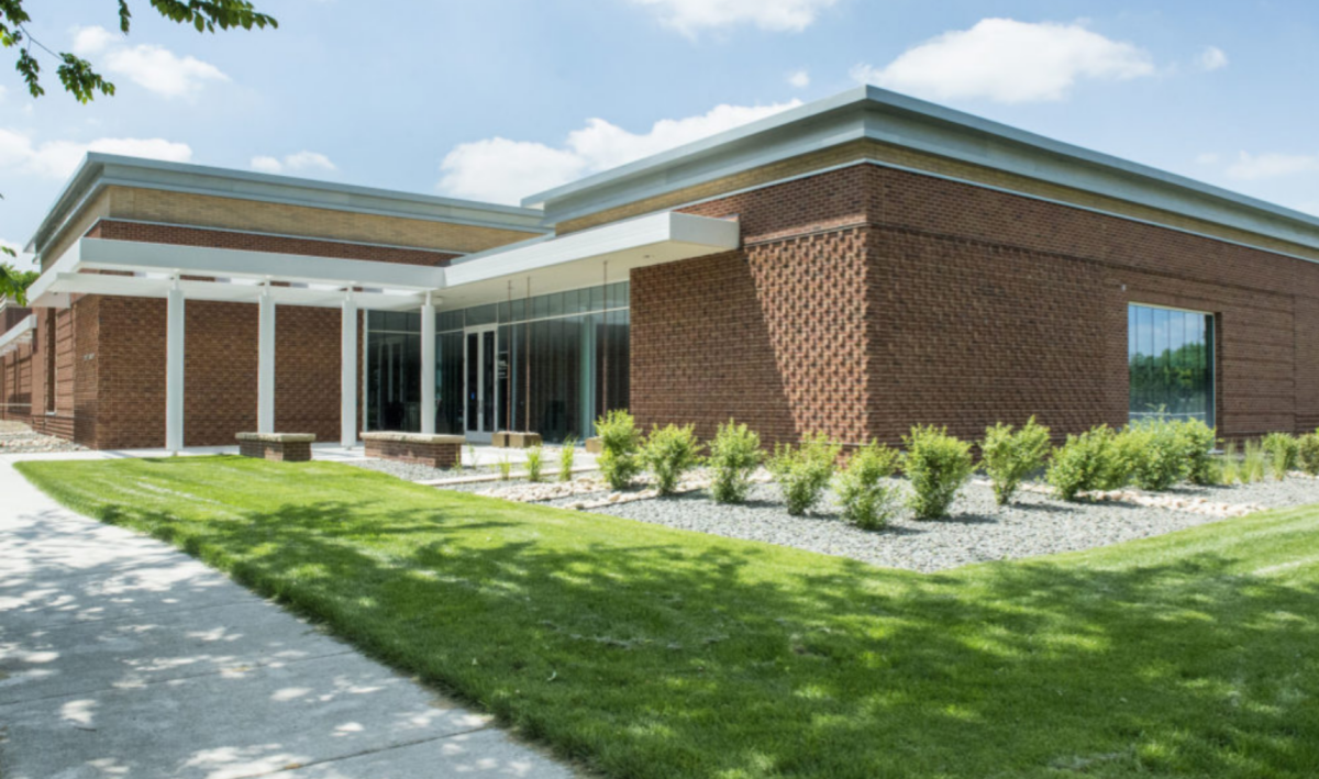 The Avenir Museum - a brick building with white accent and posts.