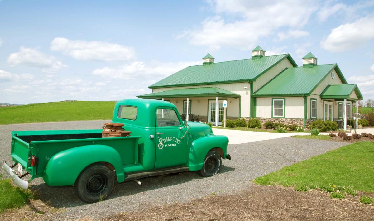 Old truck painted mint green with Stillpoint Farm painted on the side at the Milkhouse Brewery