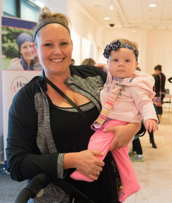 Woman holding a baby wearing pink