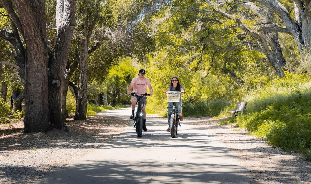 Couple riding e-bikes on trail in Avila Beach